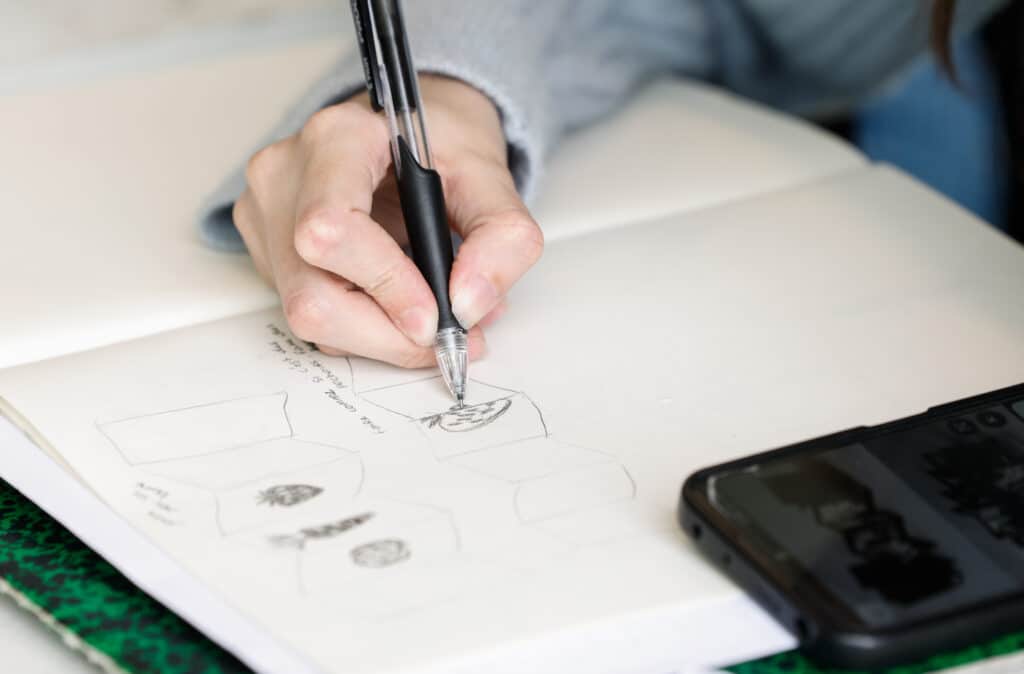 Étudiant en design graphique réalisant une esquisse de packaging à la main